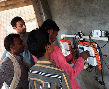 SHRI's water ATM system. Anoop Jain, SHRI's founder, is in the back. SHRI's water ATM system. Anoop Jain, SHRI's founder, is in the back.